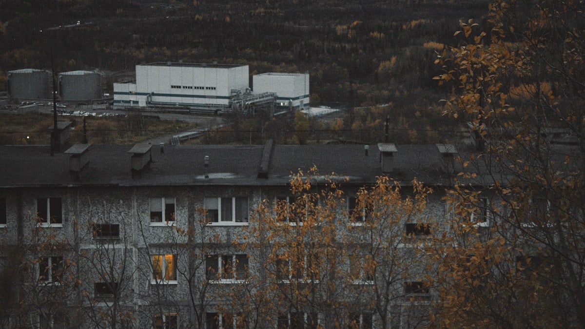 Industrial buildings and apartment block in autumn